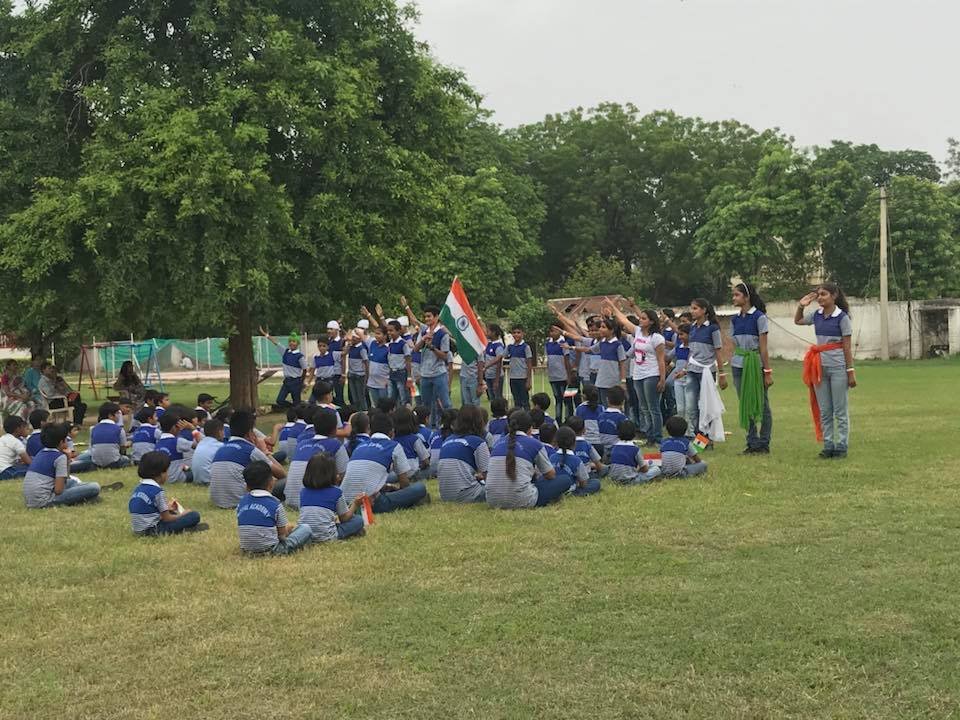 Royal Academy Alwar students holding the Indian flag on Independence Day
