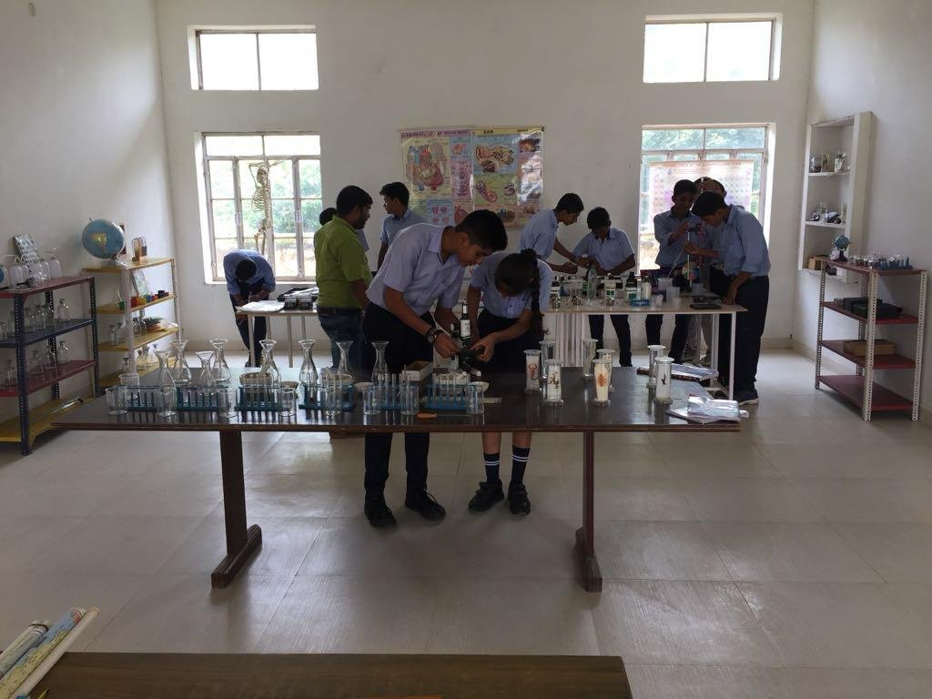 Royal Academy Alwar students performing practical work in the science lab